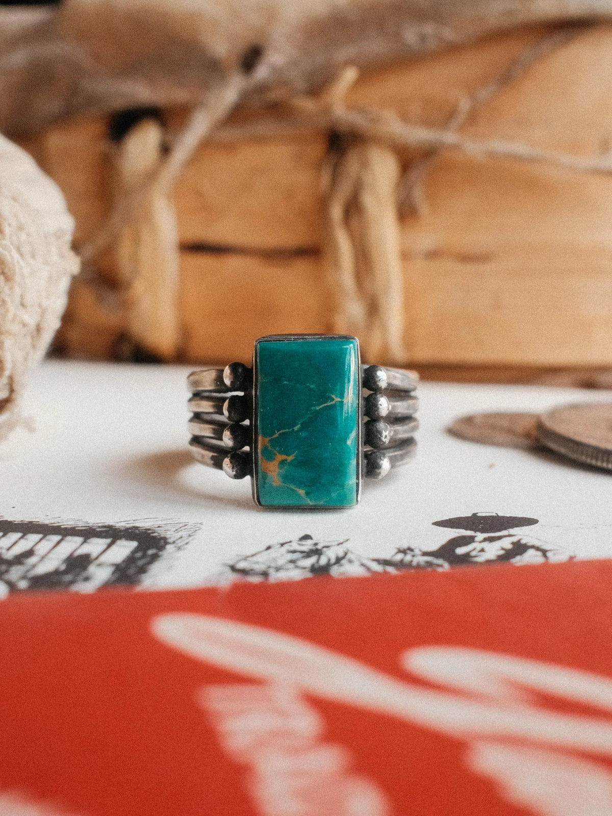 A four-prong split shank dressed in sterling beadwork and set with Royston turquoise from Nevada, hand-stamped throughout