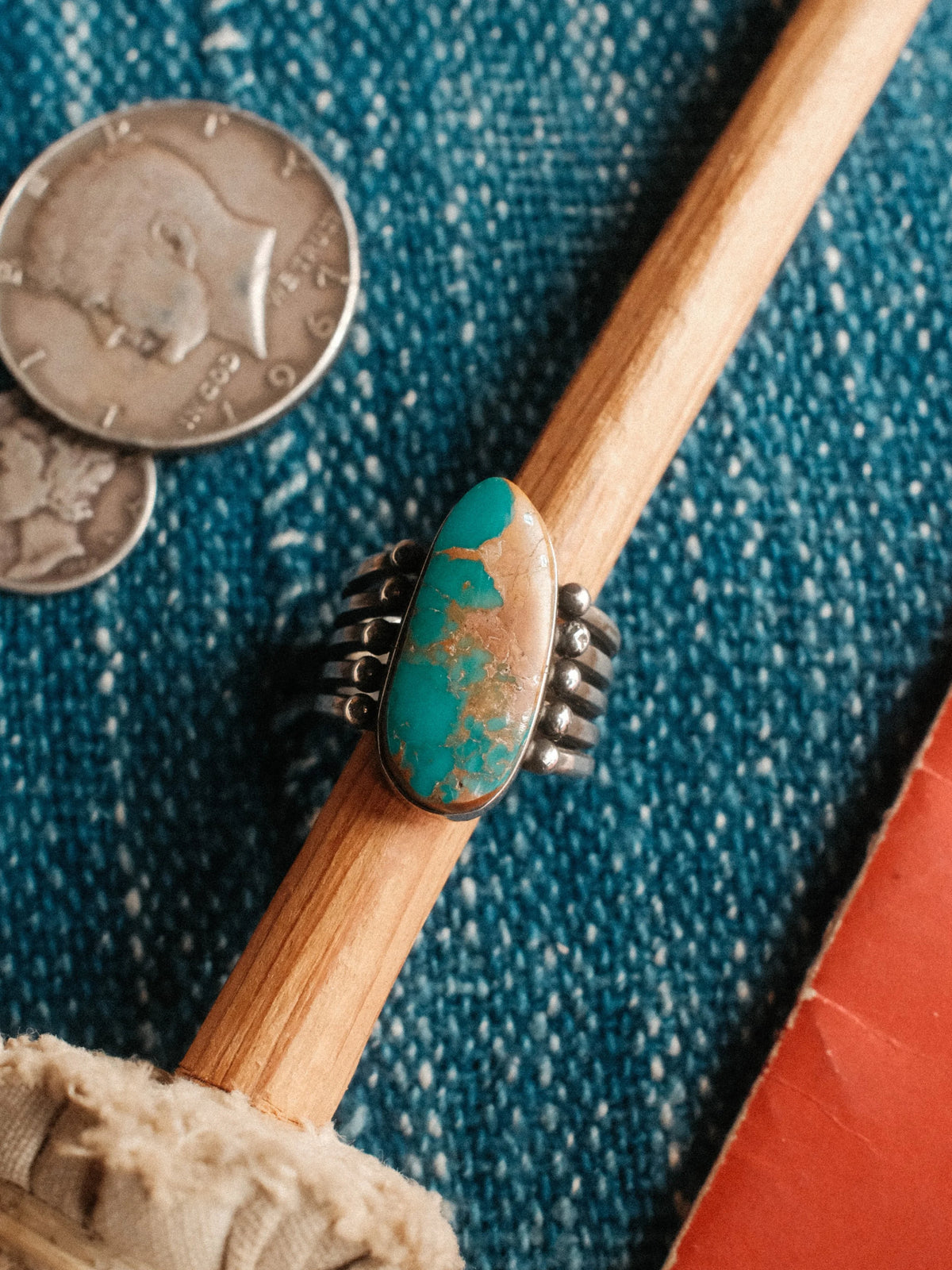 A five-prong split shank with sterling beadwork, set with Royston turquoise from Nevada and hand-stamped
