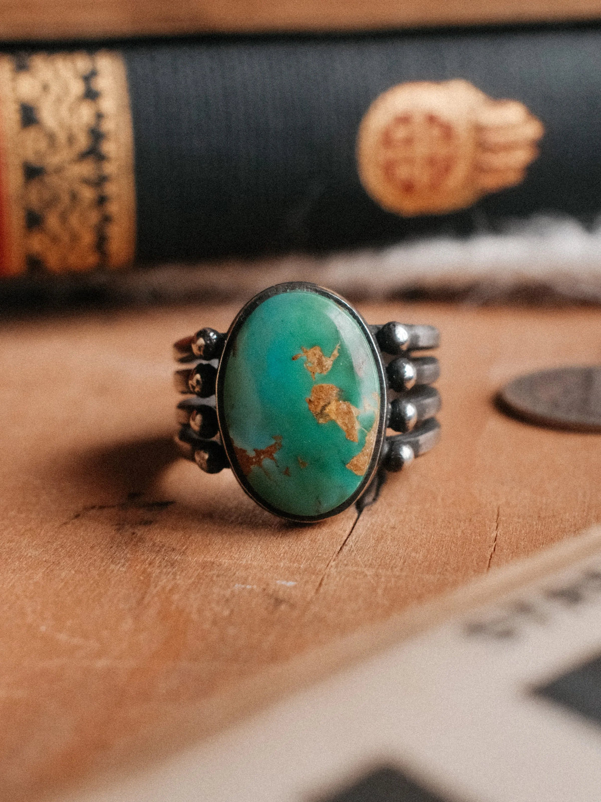 Royston turquoise on a four-prong split shank with sterling beadwork, hand-stamped with Chad's own steel