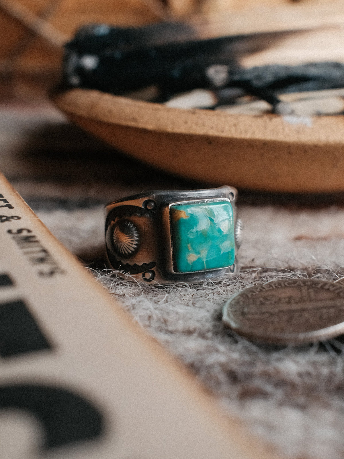 A sturdy Compadre shank with bump-out concho details, set with Royston turquoise from Nevada and hand-stamped throughout