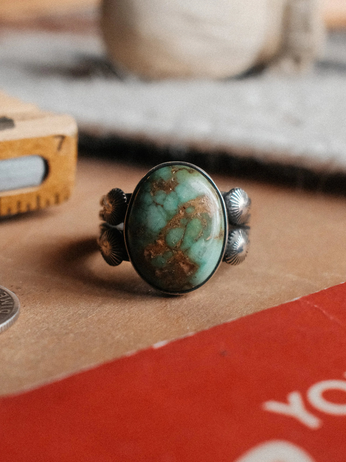 A 16×13mm Royston turquoise stone on a four-prong split shank with sterling concho details, hand-stamped. — view 2