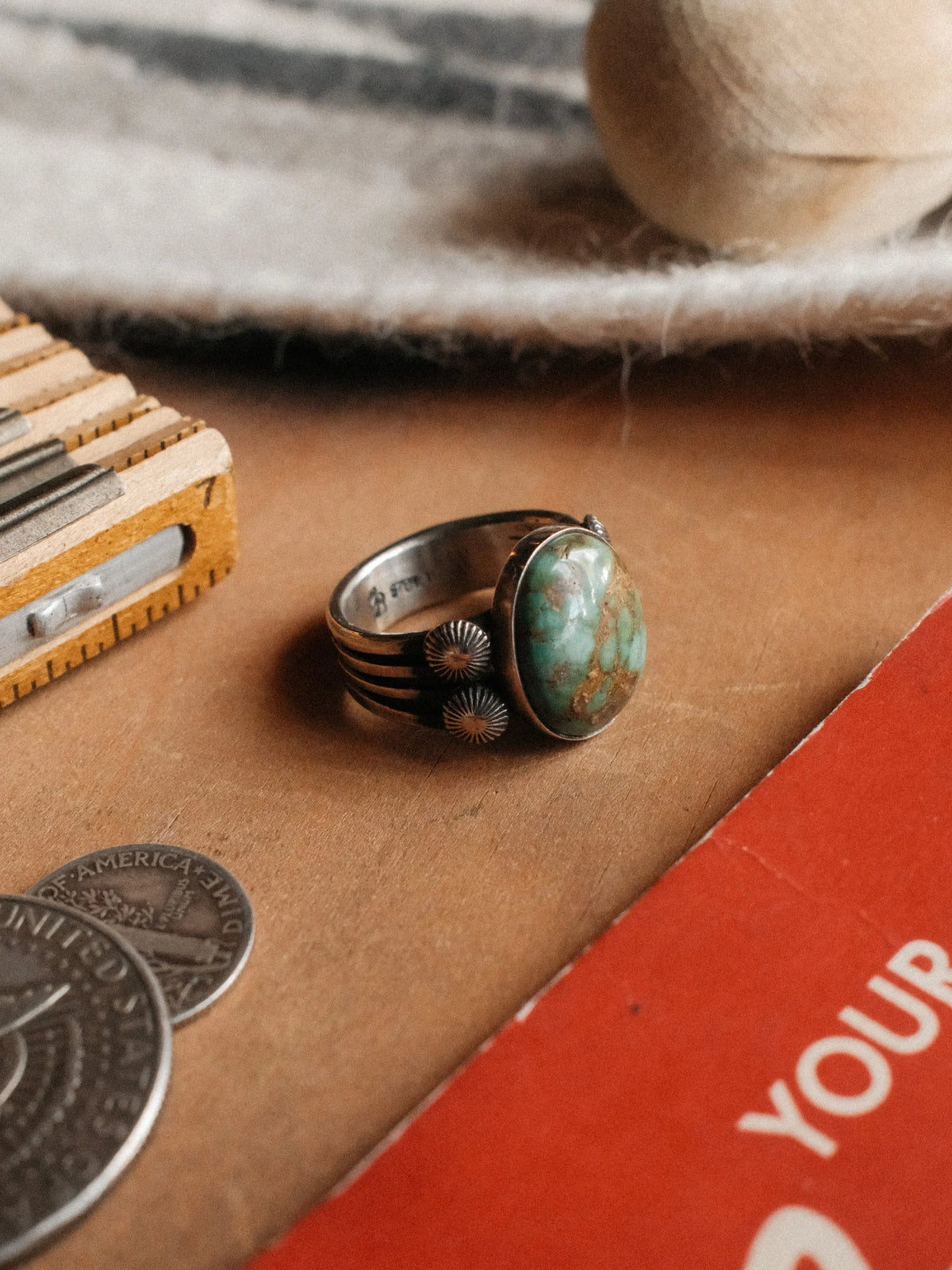 A 16×13mm Royston turquoise stone on a four-prong split shank with sterling concho details, hand-stamped. — view 4