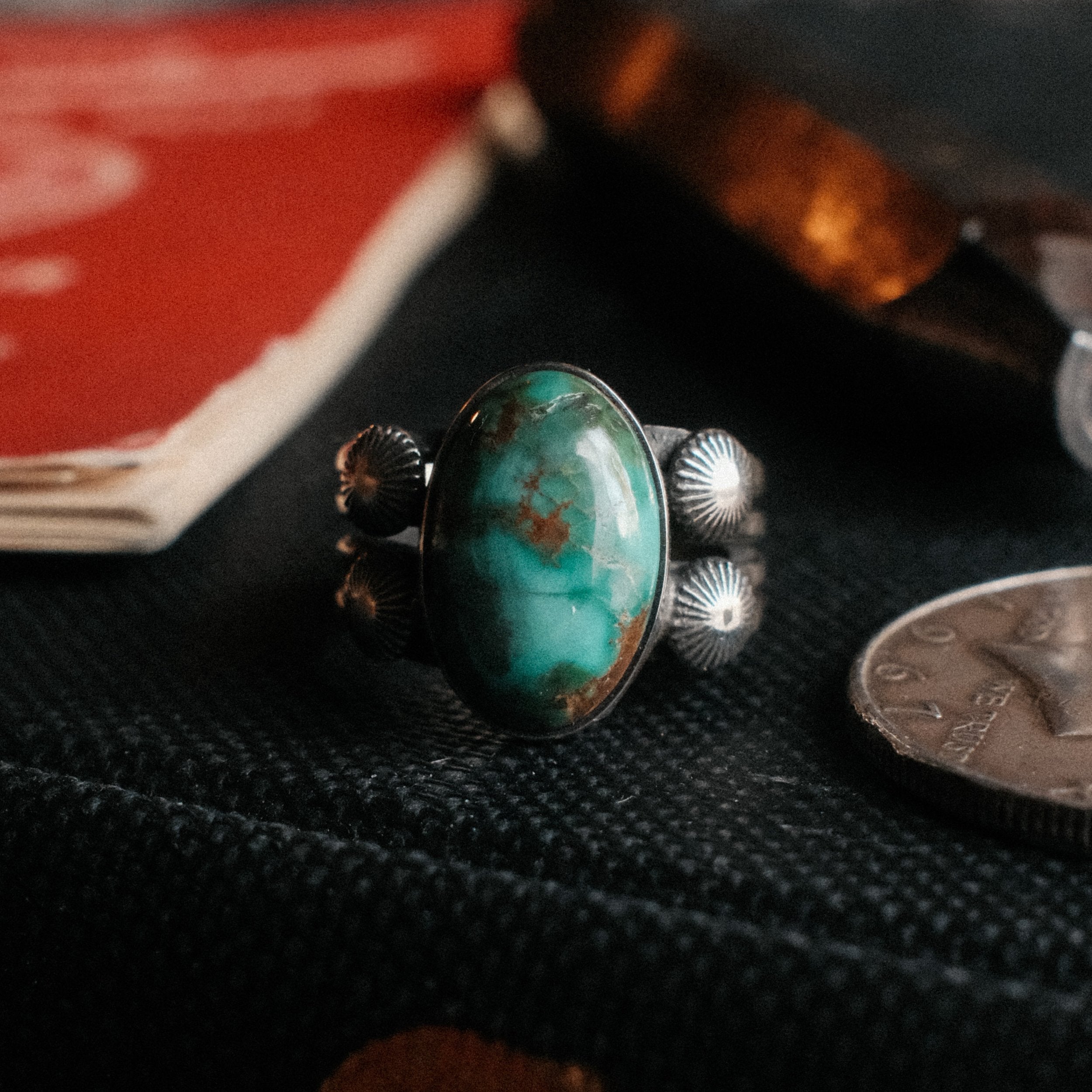 A premium 16×10mm Royston turquoise on a four-prong shank with sterling concho details, hand-stamped