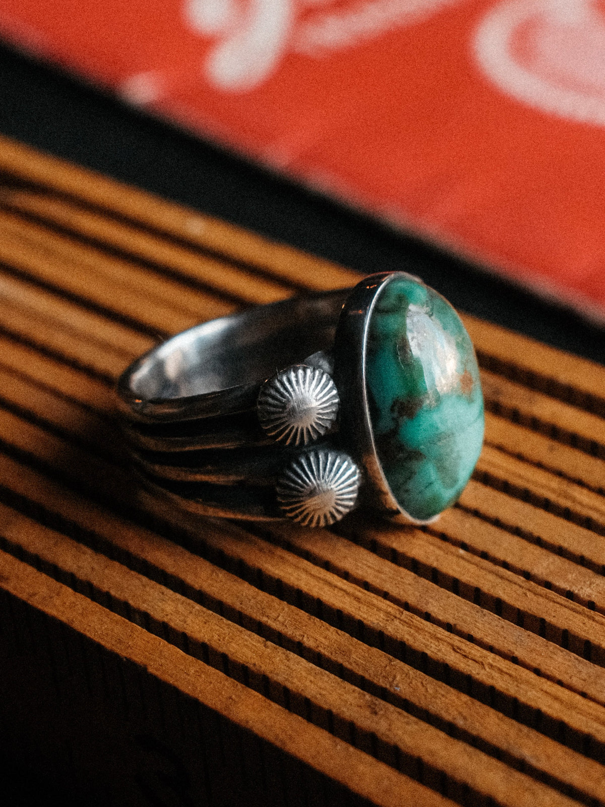 A premium 16×10mm Royston turquoise on a four-prong shank with sterling concho details, hand-stamped — view 2