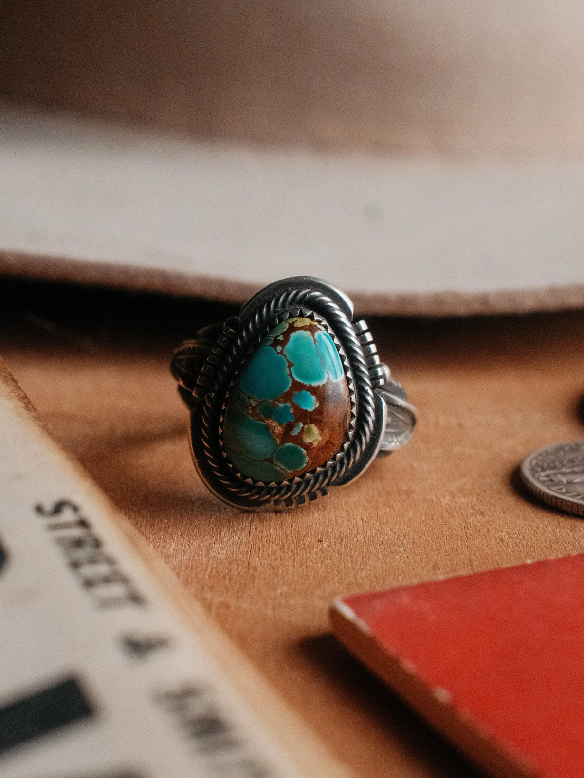Set with Sierra Nevada turquoise inside a hand-cut border and twist wire, hand-stamped throughout