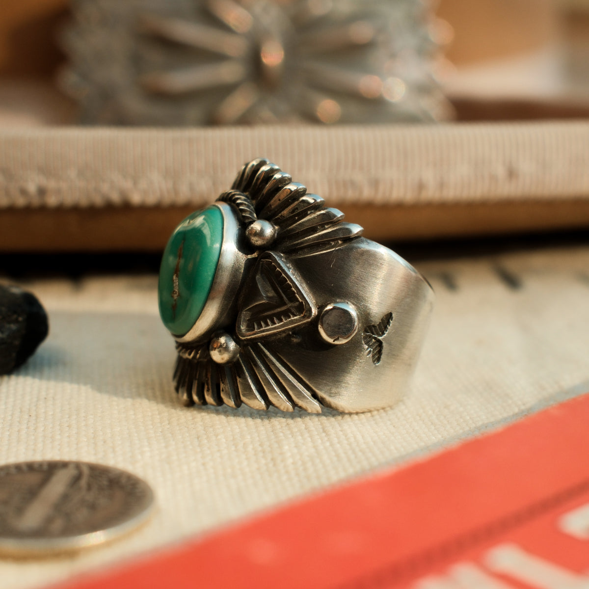 A one-of-a-kind 10×14mm Carico Lake turquoise in a smooth bezel, framed by hand-stamped rays and stamped triangular panels on a wide tapering band — view 3