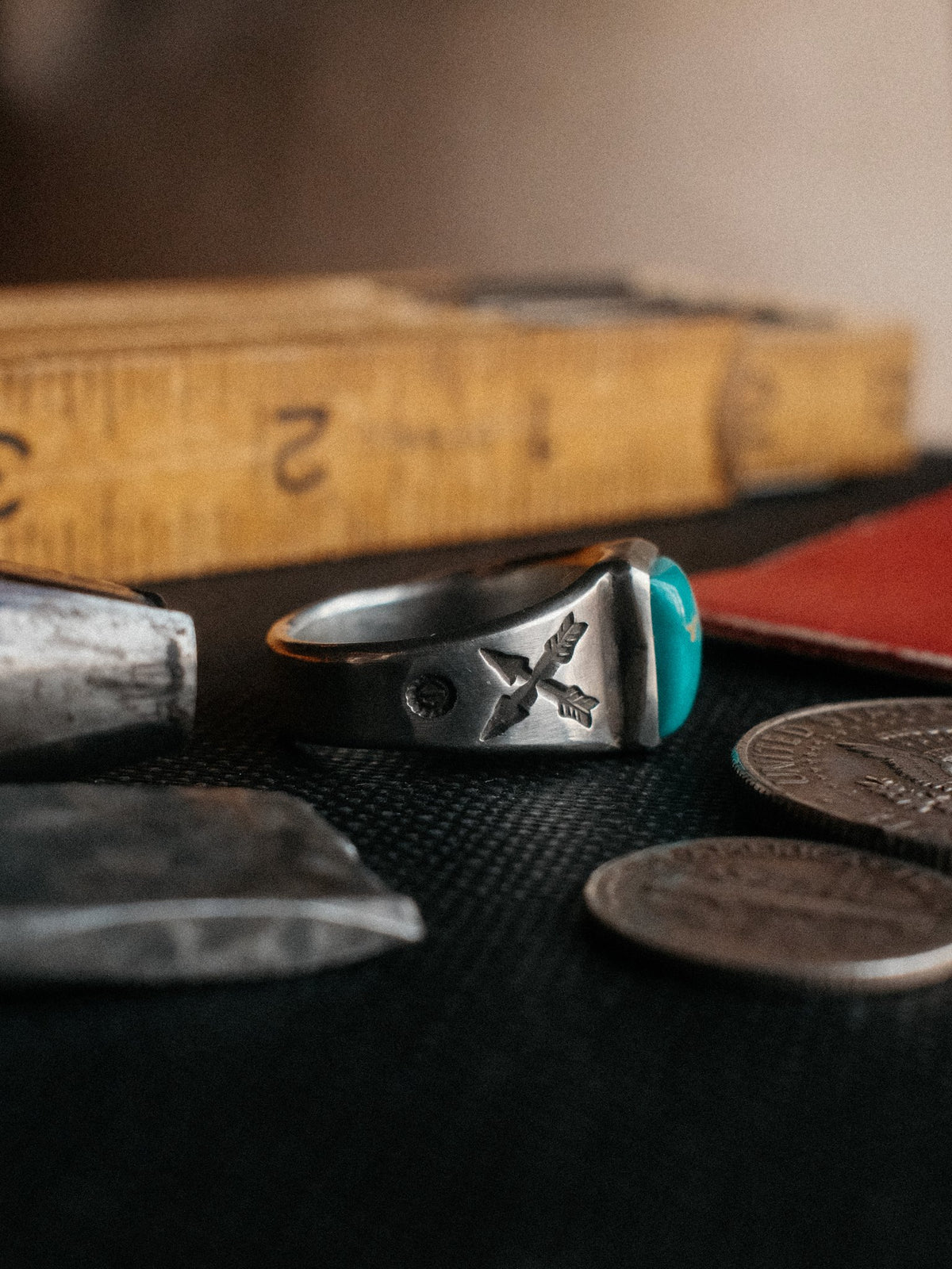 Crossed arrows struck by hand into sterling, centered on a piece of Manassa turquoise from Colorado's dormant King mine — view 2