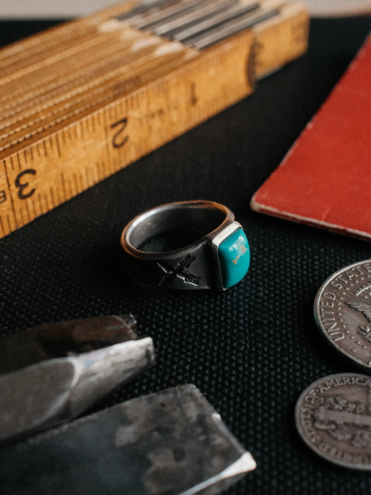 Crossed arrows struck by hand into sterling, centered on a piece of Manassa turquoise from Colorado's dormant King mine — view 3