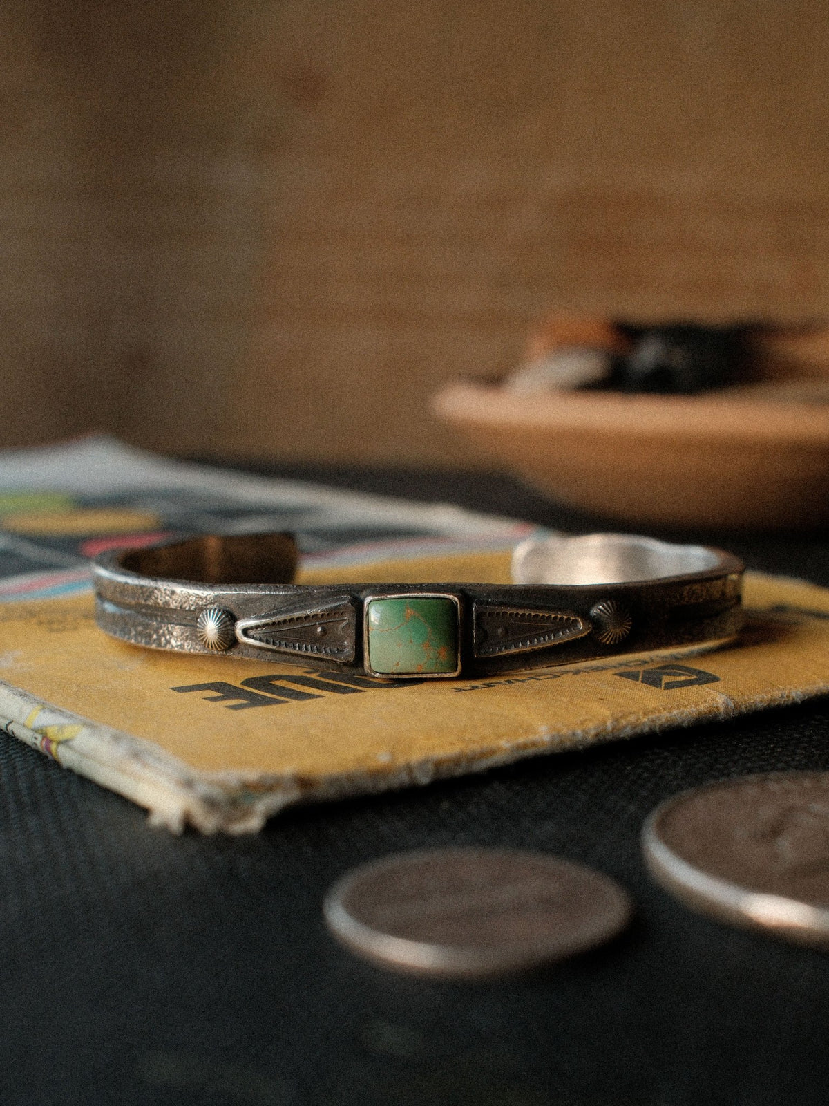 A heavier tufa-cast ingot cuff in sterling, hand-stamped and set with Royston turquoise from Nevada