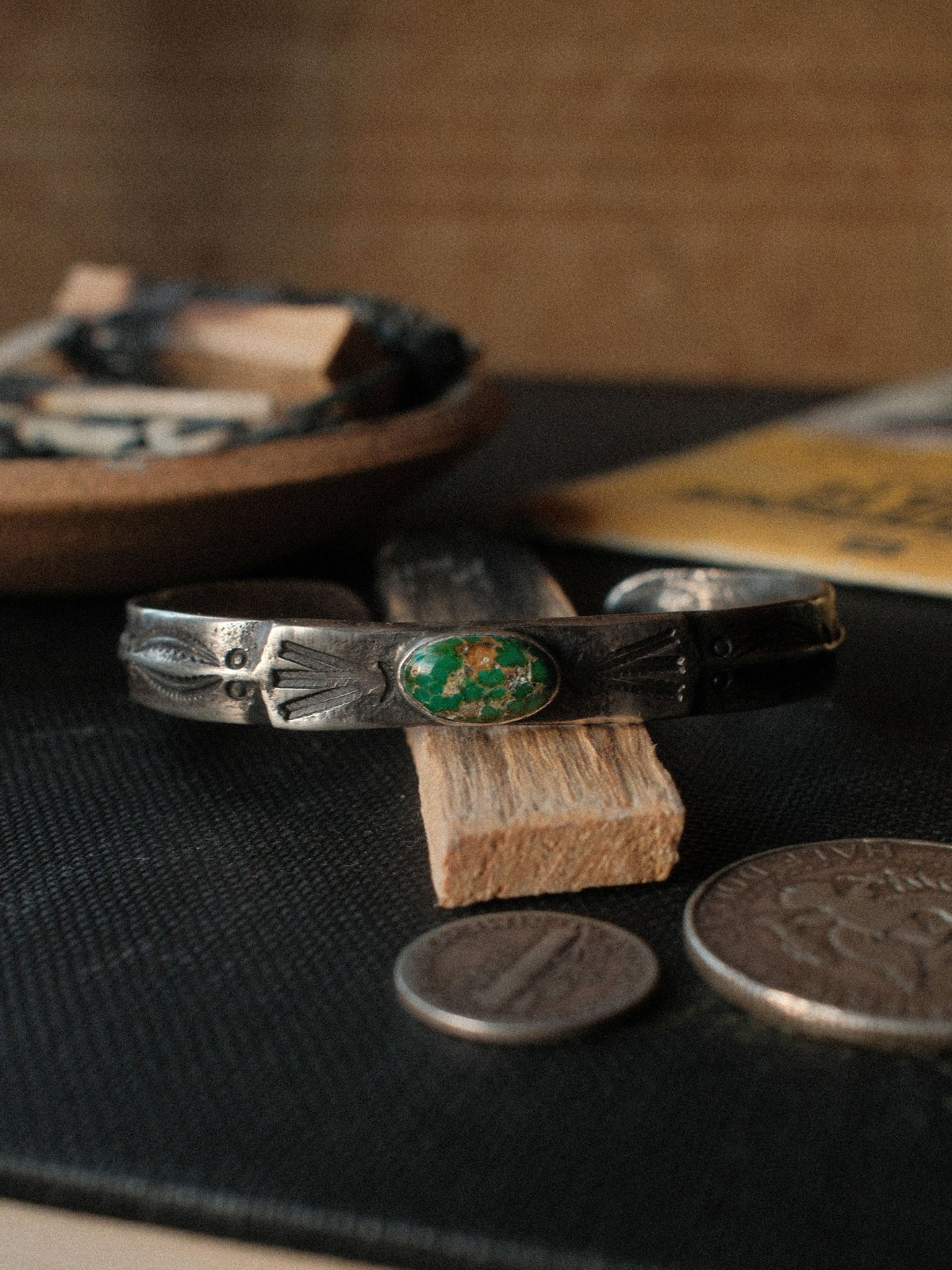 Poured from a tufa-cast ingot and worked flat across the top, this cuff is hand-stamped and set with Royston turquoise from Nevada