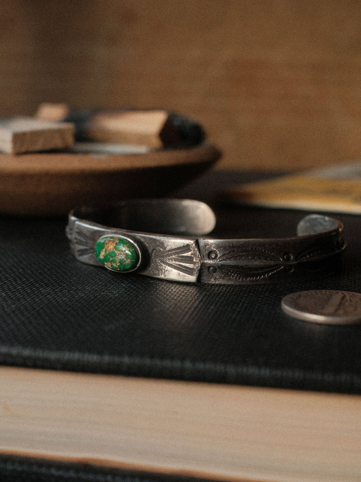Poured from a tufa-cast ingot and worked flat across the top, this cuff is hand-stamped and set with Royston turquoise from Nevada — view 2