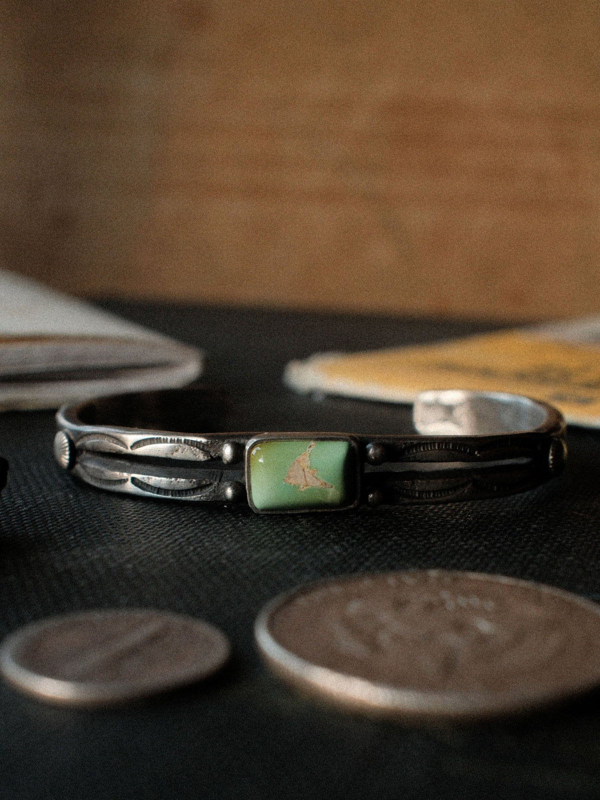 A tufa-cast split cuff hand-stamped with Chad's own steel and set with Royston turquoise