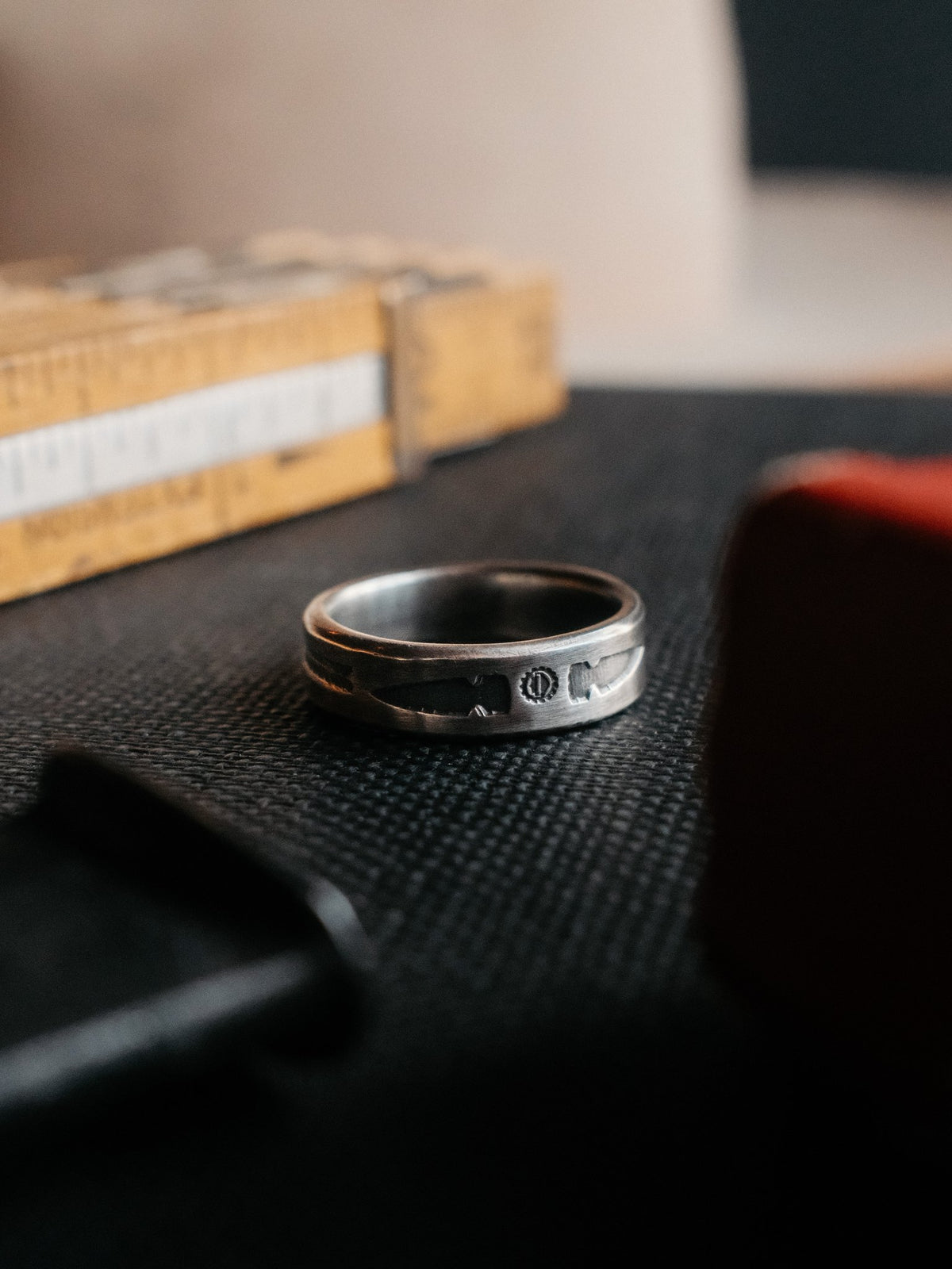 A sterling band hand-stamped with an arrowhead struck from Chad's own steel