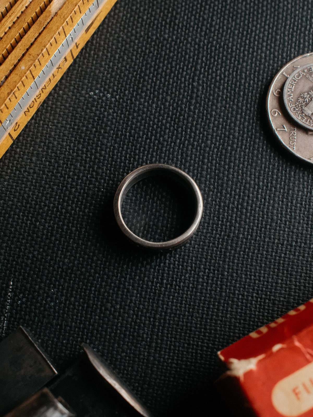 A sterling band hand-stamped with an arrowhead struck from Chad's own steel — view 2