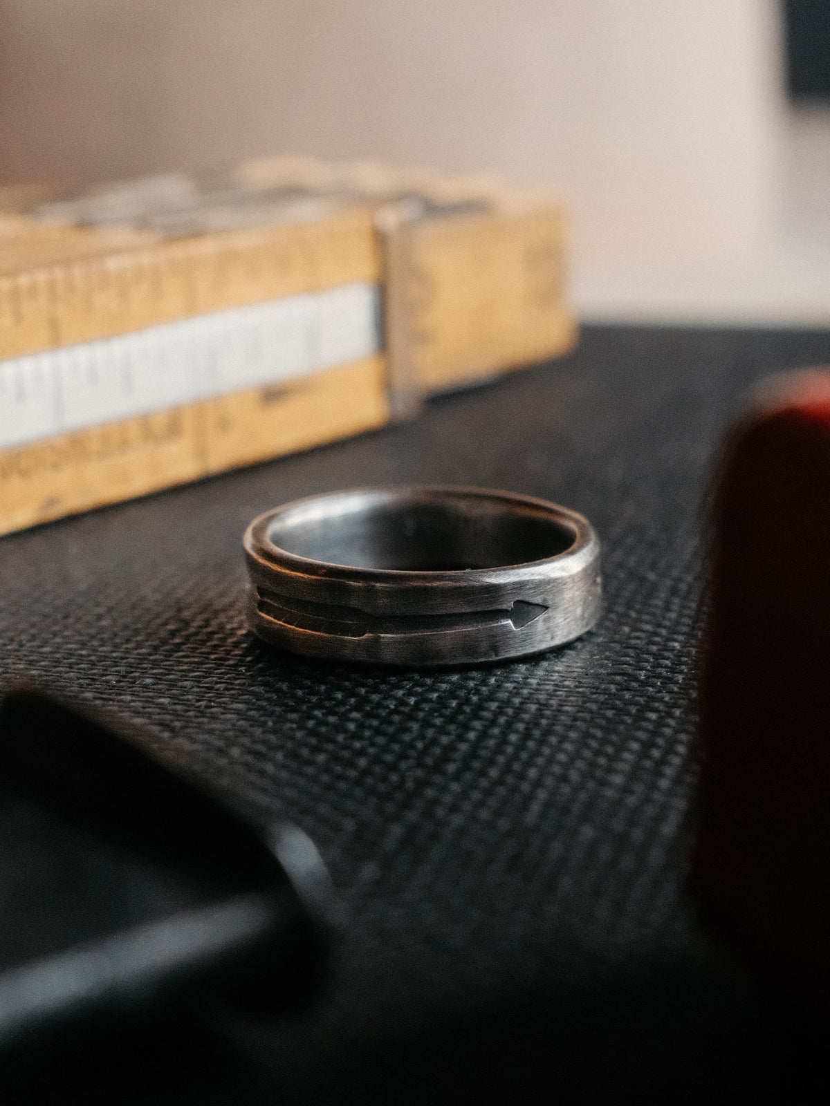 A sterling band hand-stamped with an arrowhead struck from Chad's own steel — view 3