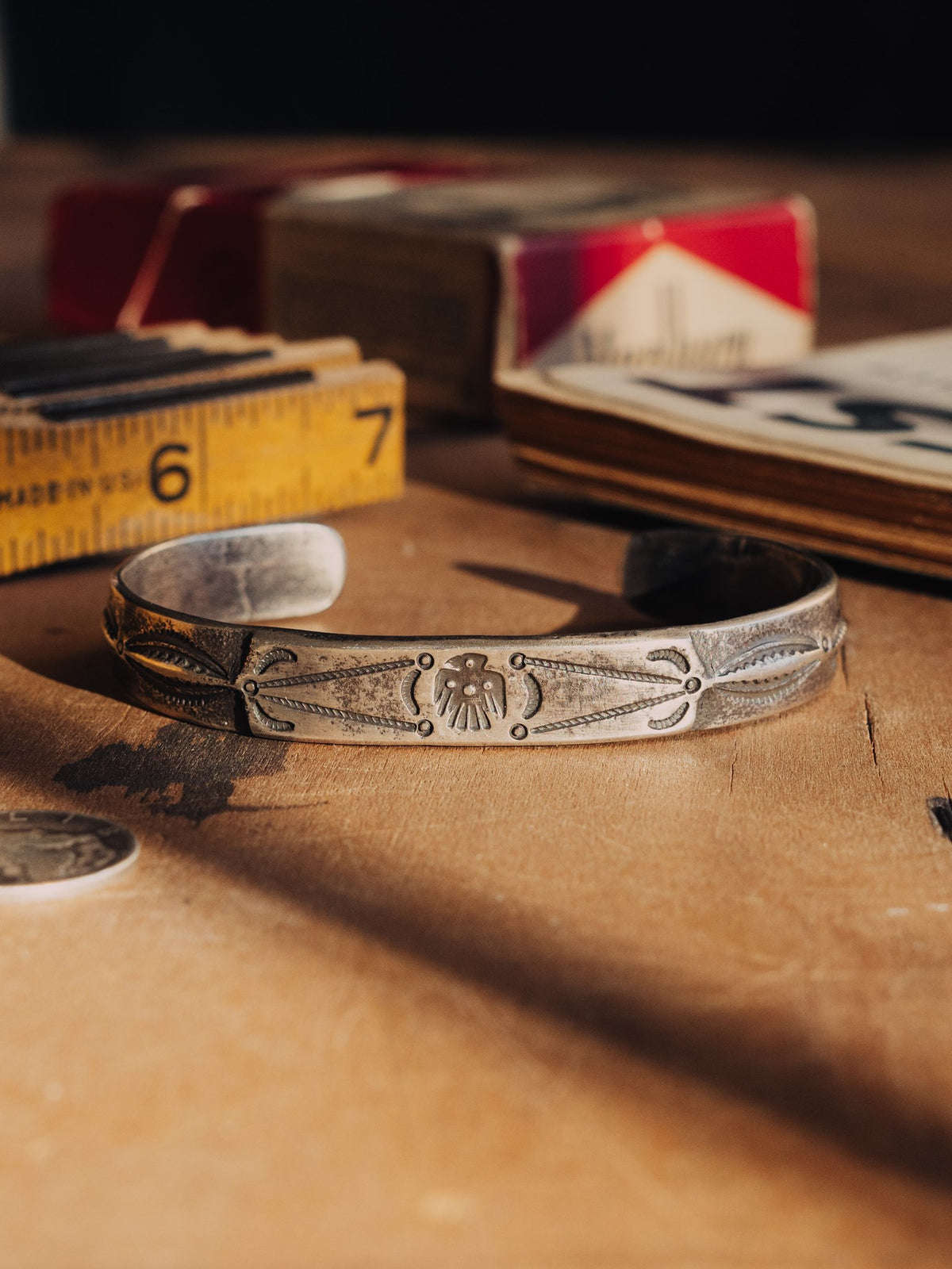 Poured from a tufa-cast ingot and hand-stamped with a thunderbird across the face, worked in coin silver